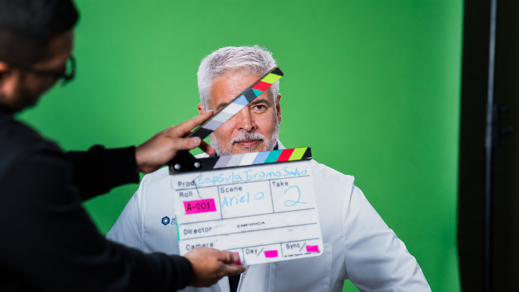 Dr. Ortiz on a video shoot with a clapperboard in front of him.
