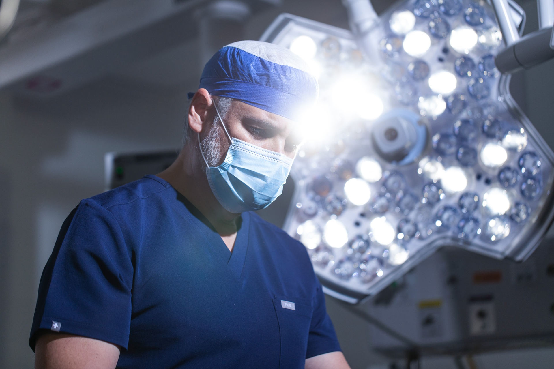 Dr. Ortiz in the operating room under surgical lights.